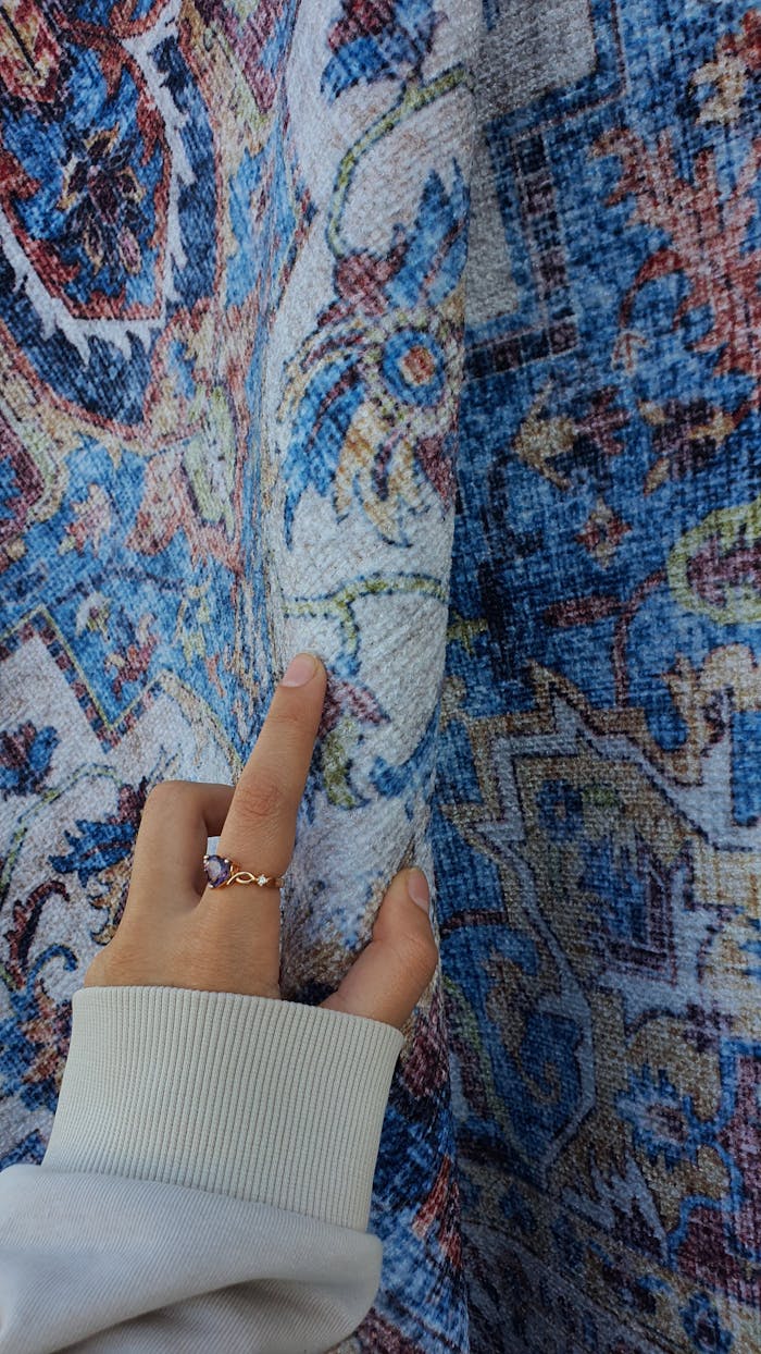 Woman Hand Touching Ornate Carpet